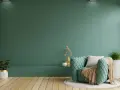 Miętowa kanapa i zielone ściany tworzą przytulną atmosferę. Inspirujące kolory farb ściennych do Twojego wnętrza.